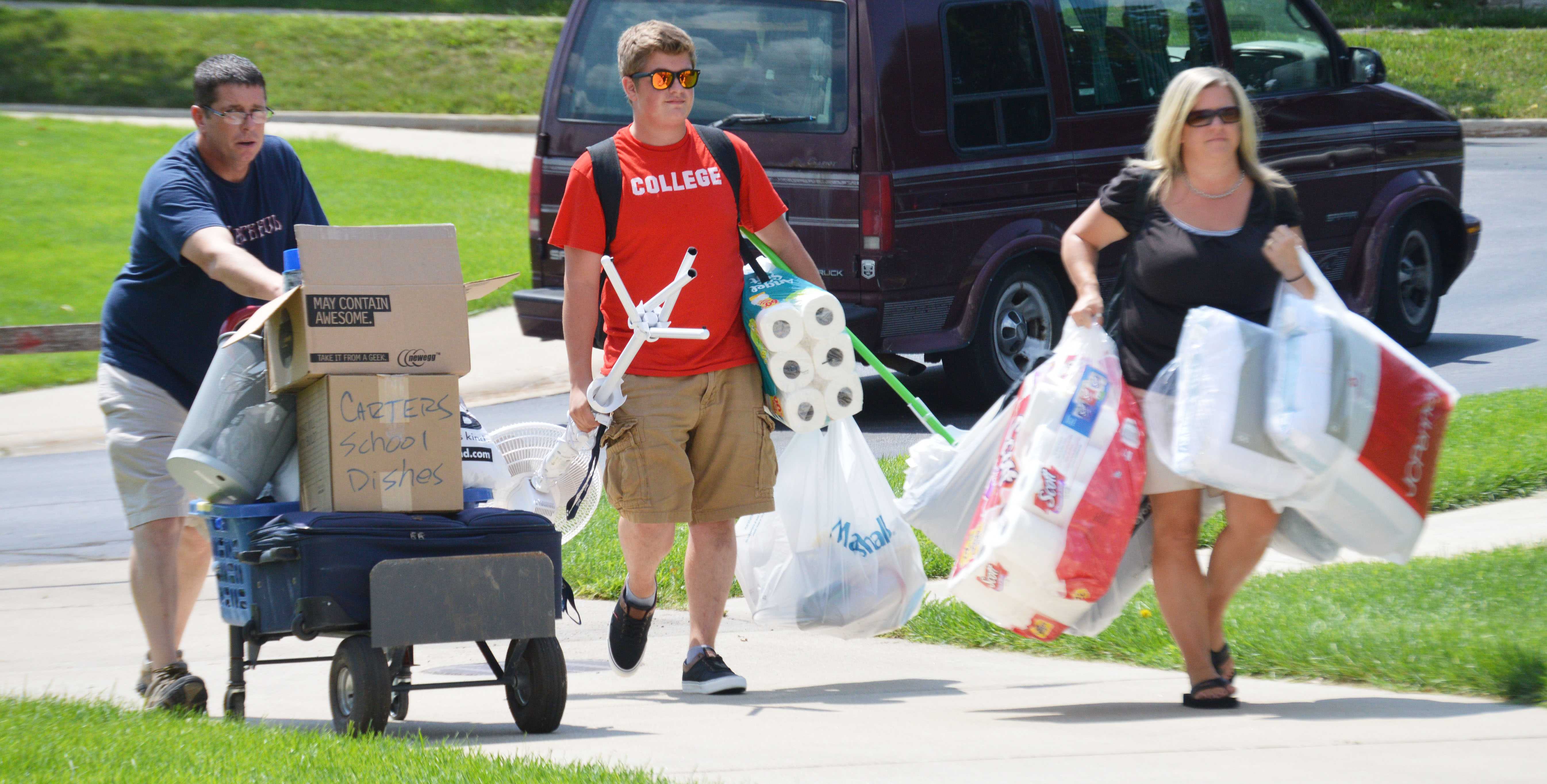 Does this not say all there is to say about college? A new student and his parents carry furniture and supplies into River Crossing Student Housing. PHOTO/C.A. PRINTUP