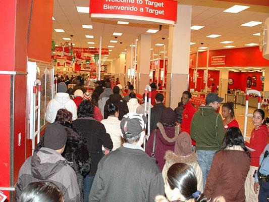 Shoppers flood into Target on Black Friday. Retail stores are opening earlier and earlier on the holiday every year. Some will even stay open on Thanksgiving this year.  Photo via/Wikimedia Commons