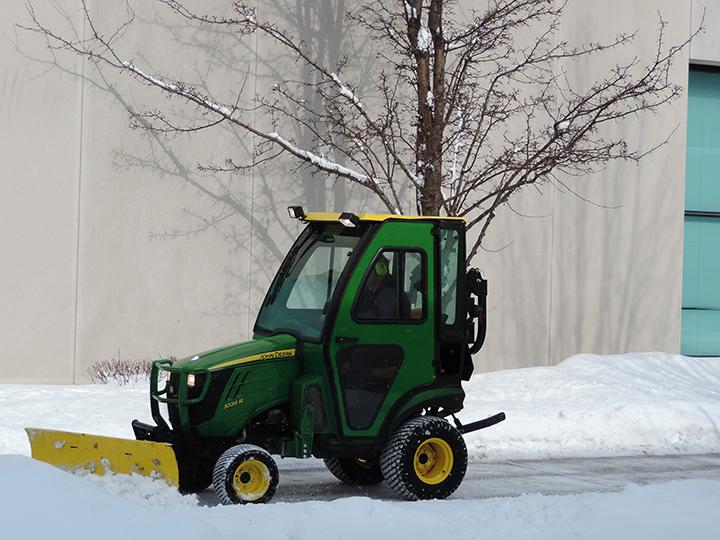 A groundskeeper plows snow from a sidewalk after a snow. (Preface Photo/NEIL KING) 