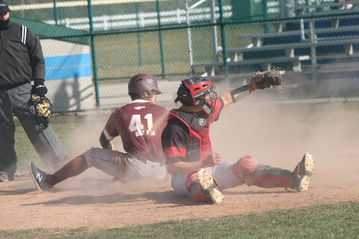 Catcher TJ DeHerrera gets flipped over home plate, yet still able to apply the tag at home, saving a run from scoring after impressive throws from Miller and Thomas.

Photo/Casey McDonald