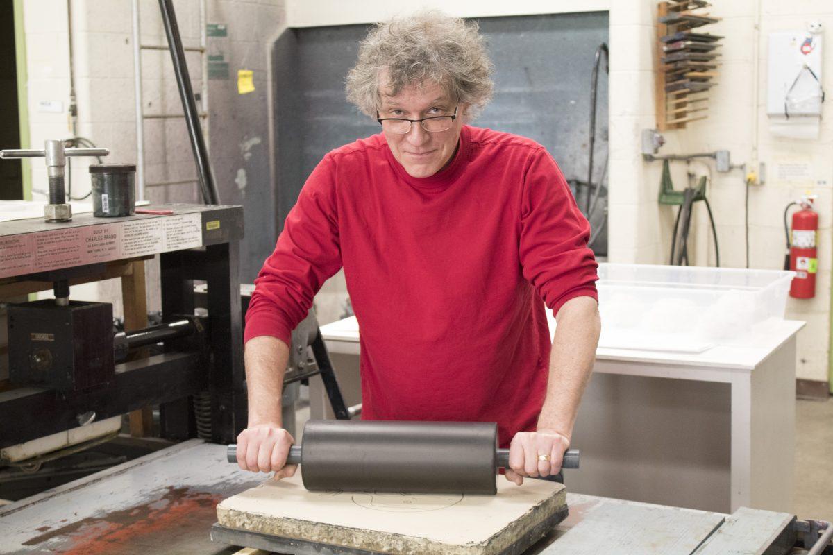 Bill Tourtillotte, lecturer in fine arts, prints on a lithography stone. PHOTO BY/KATE LUCE