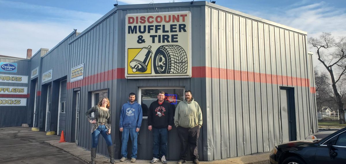Photo // Evelyn Kowalski - 
DISCOUNT MUFFLER AND TIRE TEAM. The team, Joy, Chris, Mike and Jake, stand in front of the shop, taking pride in their hard work for their community. 
